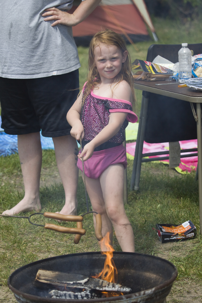 LISA-ANN ISHIHARA | THE VINDICATOR..Chloe Morgan, 4, of Niles roasts some food on the fire on the first day of Jonesfest at Nelson Ledges Quarry Park.
