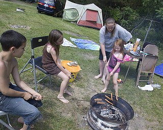 LISA-ANN ISHIHARA | THE VINDICATOR..L-R Tyler Walker, 9, Elizabeth Morgan, 7, Angela Clemens, and Chloe Morgan, 4, all of Niles, roasts food on the first day of Jonesfest at Nelson Ledges Quarry Park.