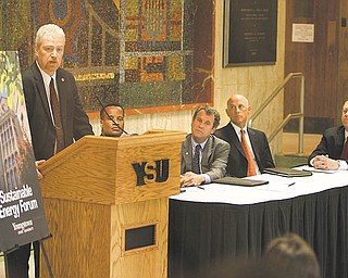 Eric Davis, at podium, of the National Electrical Contractors Association and International Brotherhood of Electrical Workers, lauds Youngstown State University for its commitment to sustainable energy. Davis joined Youngstown Mayor Jay Williams, U.S. Sen. Sherrod Brown, Michael Shaut of Carbon Vision and YSU President David Sweet at a press conference Tuesday announcing the installation of solar panels on the roof of YSU's Moser Hall.