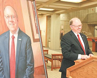 Youngstown State University President David C. Sweet stood next to a mirror image of himself at the unveiling of his official presidential portrait. It will hang in the foyer of Tod Hall along with the portraits of the university's first five presidents. Sweet's 10-year tenure at the helm ends with his retirement June 30.