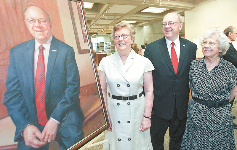 Youngstown State University President David C. Sweet is flanked by two key women in his life, his wife, Pat, left, and his mother, Esther Sweet, as they admire his official presidential portrait.
