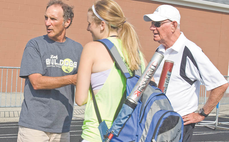 Poland High softball coach Reid Lamport, left, and assistant coach Dom DeLuca talk with senior Nicole White during Tuesday’s practice. Thursday, the Bulldogs play New Concord John Glenn in a state semifi nal game in Akron.
