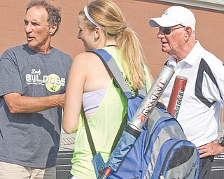 Poland High softball coach Reid Lamport, left, and assistant coach Dom DeLuca talk with senior Nicole White during Tuesday’s practice. Thursday, the Bulldogs play New Concord John Glenn in a state semifi nal game in Akron.