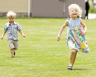Ian and Avery Bandy Zalatoris, age 3 and 4 respectively, have some fun at Harrison Field on North Walnut Street in Youngstown before a groundbreaking ceremony at the field marking the start of the construction of Harrison Commons, which will be a focal point of the Smoky Hollow revitalization project.
