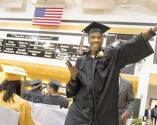 Darien Young motions for applause after he accepts his diploma during Warren G. Harding High School’s 2010 commencement ceremony Wednesday.