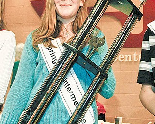 Julia Miglets of Springfi eld Elementary School holds the champion trophy that she received after winning the 77th Vindicator Spelling Bee.