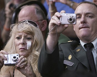 ROBERT K. YOSAY | THE VINDICATOR..Proud parents Julie and Derek Rubicky capture the moment as their son William Rubicky enters - at Boardman High Schools Graduation 2010 held at the school -30
