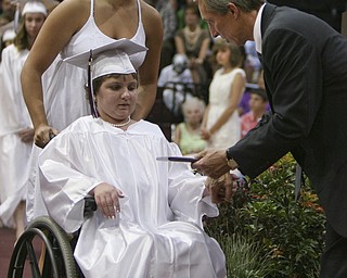 ROBERT K. YOSAY | THE VINDICATOR..Abbey Przicina recieves her diploma from Mark Fulks - president of the school board . helping her is Miah Gasparek at Boardman High Schools Graduation 2010 held at the school -30