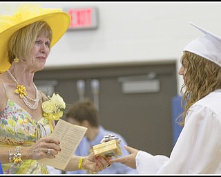 Geoffrey Hauschild|The Vindicator.Retiring teacher, Barbara Stacy, receieves a gift from Danielle Sabelli on behalf of her graduating class during Poland's 2010 Commencement Ceremony at the high school gymnasium on Sunday afternoon.