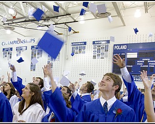Geoffrey Hauschild|The Vindicator.Trevor Jones looks up as he and his fellow graduates throw their caps during Poland's 2010 Commencement Ceremony at the high school gymnasium on Sunday afternoon.