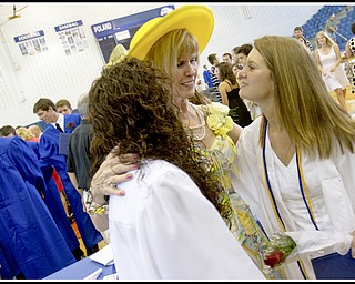 Geoffrey Hauschild|The Vindicator.Retiring teacher, Barbara Stacy, (center) shares a moment with graduates, Santina Mastoris (left) and Katie Mulholland (right), following Poland's 2010 Commencement Ceremony at the high school gymnasium on Sunday afternoon.