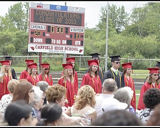 LESLIE CUSANO | THE VINDICATOR.Canfield High School graduates process onto the Bob Dove Field during commencement exercises Sunday.