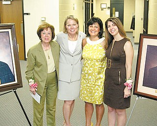 Portraits were unveiled at the Martin P. Joyce Juvenile Justice Center on East Scott Street in Youngstown. At left is the portrait of Judge Joyce. At far right is the portrait of Judge James McNally. Between the portraits are, from left, Betty Joyce, wife of the late Judge Joyce; Judge Theresa Dellick of juvenile court; Linda McNally, wife of the late Judge McNally; and Kerry McNally, the judgeÕs daughter, who recently graduated from law school. The portraits were unveiled at a ceremony Monday.