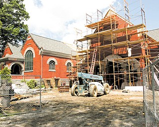 The blue vehicle is parked in front of the planned new entry at Lisbon's Lepper Public Library. The door and the overall expansion will match the original design to make the library look like an English country church.