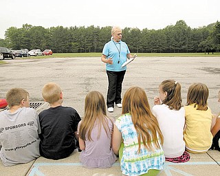 Dolores Saunders, 70, of Canfield, retired Friday after 41 years with the Canfield School District. Saunders, a physical-education teacher, goes over the rules of kickball during a session outside with a class at Hilltop Elementary.