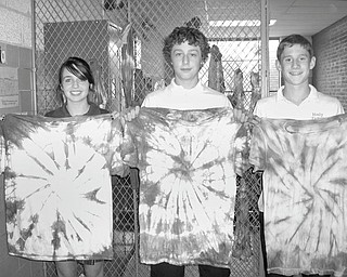 Eighth-grade students at Holy Family School in Poland learned how to tie dye clothing as a final project in Janet Cadman’s class. Proudly displaying the colorful shirts they created during the end of the year project are, from left, Miah Appugliese, Ethan McDanel and Clayton Walker.