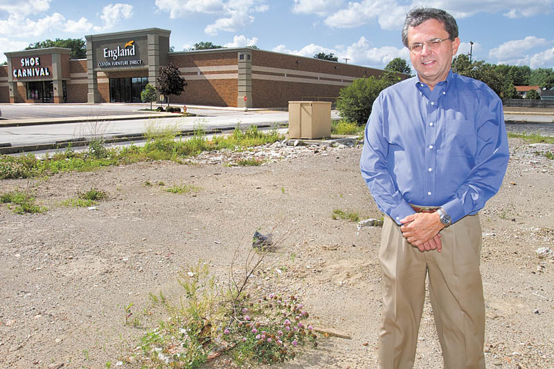 Bill Kutlick, a broker for Kutlick Realty, stands in a vacant lot on which an Arby’s restaurant formerly stood on U.S. Route 224 in Boardman. The property will be home to a new 4,500-squarefoot Verizon Wireless store. Boardman’s retail corridor is undergoing several redevelopment projects as the impact of the economic recession begins to soften.