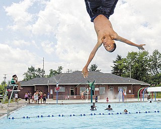 Lamar Robinson, 13, of Youngstown does a flip from the diving board at North Side Pool shortly after the pool opened Wednesday. The opening was made possible thanks to funding through the Mahoning-Youngstown Community Action Partnership.