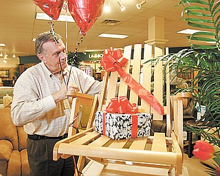 Wiilliam D. Lewis |The Vindicator  Lazy Boy store owner ron D'Alseandro shows off a relpica of the original Lazy Boy chair.