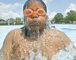 Jason Martin, 12, of Youngstown emerges from the cool water of North Side Pool.