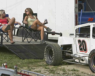 ROBERT K. YOSAY | THE VINDICATOR..Cool seats as lawn chairs on the car trailer as Amber Butcher of Cortland and Amanda Dunbar  of Kinsman  pass the time waiting for the races to start -30-