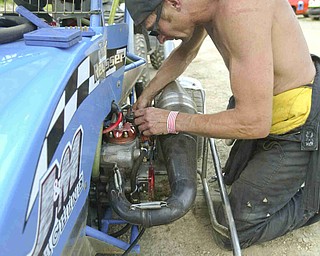 ROBERT K. YOSAY | THE VINDICATOR.. Pit Crew / Driver  Tod Reusser of Minerva adjusts the carburetor jets on his engine before the race.  -30-