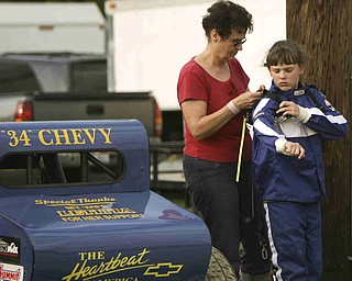 ROBERT K. YOSAY | THE VINDICATOR..Not just a guys  raceing as Carolyn Bays adjusts the seat belt harness of Maranda Myers before the race  . both are from Minerva .-30-