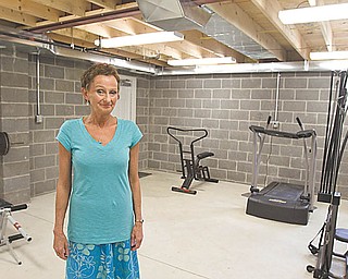 Jan Baharis, program director of the Daybreak Youth Crisis Shelter on Homestead Avenue, stands in the recreation area in the basement of a new $130,000 addition to the facility for runaway and homeless youths.