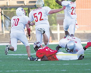 East’s Martez Penn (6), playing for Mahoning County, brings down Trumbull’s Deandre Abron of Liberty, allowing Mahoning’s Aaron Edwards (23) of Ursuline to intercept a pass meant for Abron during the 26th Annual Jack Arvin Football Classic on Thursday at Mollenkopf Stadium in Warren. Ursuline’s David Rossi (52) and Louie Alexander of Western Reserve were in on the play, which put Mahoning in position to score on the next play. Mahoning won 34-26.