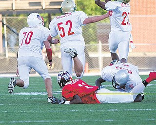 East’s Martez Penn (6), playing for Mahoning County, brings down Trumbull’s Deandre Abron of Liberty, allowing Mahoning’s Aaron Edwards (23) of Ursuline to intercept a pass meant for Abron during the 26th Annual Jack Arvin Football Classic on Thursday at Mollenkopf Stadium in Warren. Ursuline’s David Rossi (52) and Louie Alexander of Western Reserve were in on the play, which put Mahoning in position to score on the next play.  Mahoning won 34-26.