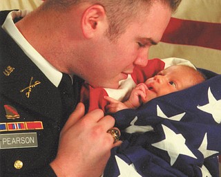 Sharing a tender moment with his 3-month-old son, Logan, is Josh Pearson of Austintown. Josh, who is serving in Afghanistan, is married to the former Katie Babinchak. He is a graduate of West Point and is a first lieutenant.