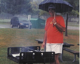 John Tabak of Campbell was such a good sport to stay out and cook for his family as they all waited under cover.