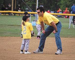 Samantha Jones, 6, is getting some T-ball advice from her coach — and  dad — Gary Jones of Canfield.