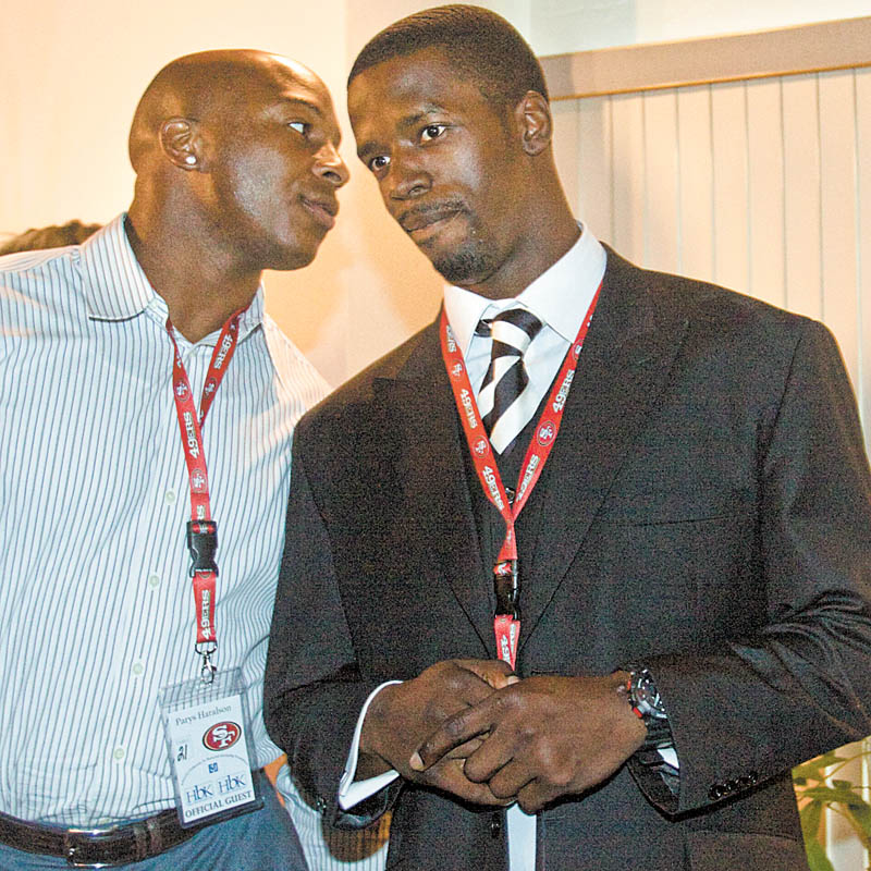 49ers Parys Haralson and Josh Morgan chat during Monday’s scholarship dinner at Leo’s Ristorante.