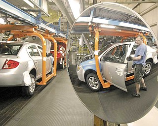 Chuck Mitchell of Salem, a 40-year GM employee, works on the Chevrolet Cobalt assembly line at the Lordstown plant Tuesday. The complex will launch the Chevrolet Cruze next month.