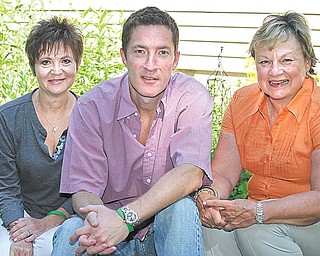Sitting by the garden planted by the late Christina Camardese Savage are, from left, Donna Savage of Boardman, her mother-in-law; Jack Savage of Liberty, her husband, and Amy Camardese of Liberty, her mother. Jack Savage is building two websites in tribute to his late wife, www.christinasgarden.org, and www.managecancer.org, to help cancer patients fi nd resources. He also plans to develop other programs to help cancer patients.