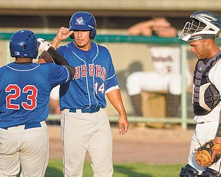 Mahoning Valley Scrappers catcher Moises Montero looks down as Lance Durham (23) and John Roberts (14) of the Auburn Doubledays celebrate after scoring in Tuesday’s game at Eastwood Field in Niles. The Doubledays shut out the Scrappers, 5-0, for their second time in a row.