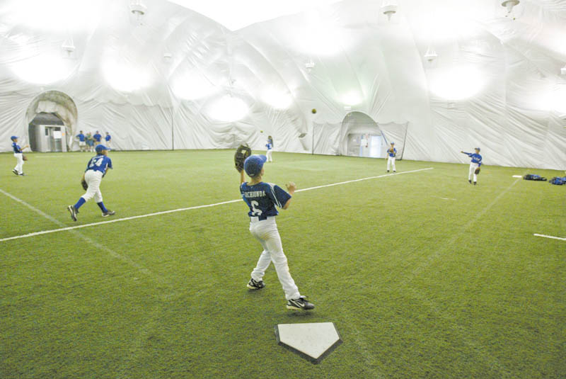 Youth baseball players practice at the Glacier Baseball Facility in Struthers inside the dome.