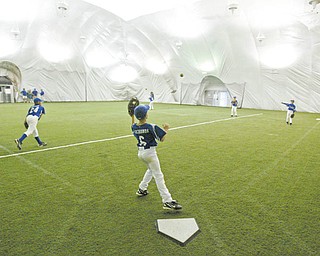 Youth baseball players practice at the Glacier Baseball Facility in Struthers inside the dome.