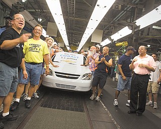 Lordstown GM employees walk the last Cobalt down the conveyor belt on, Wednesday, June 23, 2010.