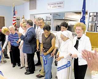 Volunteers prepare refreshments in the newly remodeled kitchen at the St. Vincent De Paul Society Dining Hall. The facility, which serves meals to people in need, just completed a renovation.