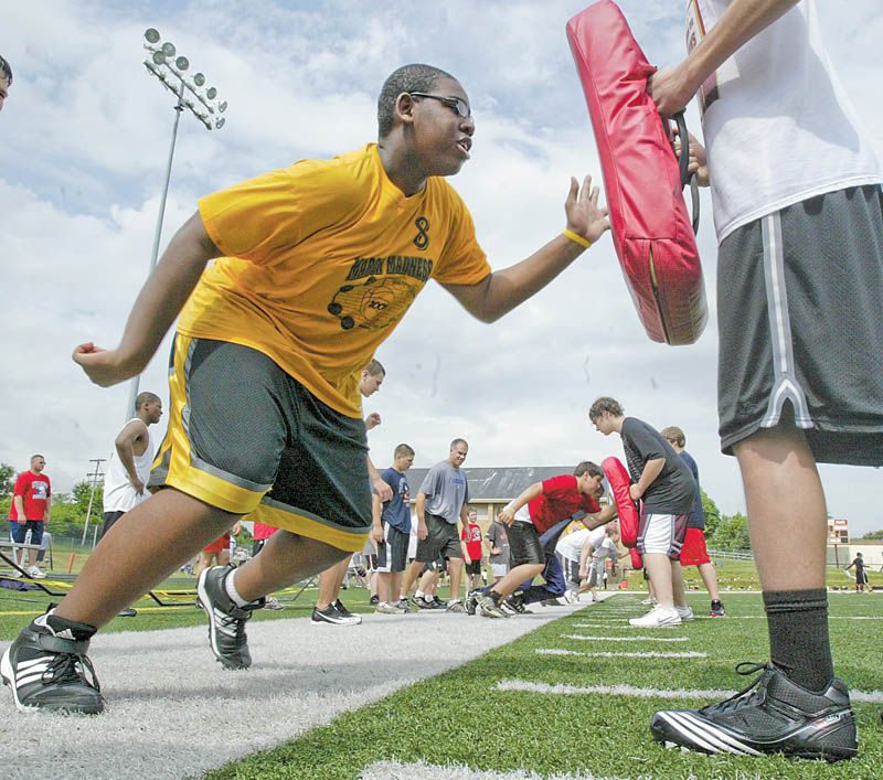 Ted Everett, 13, of Youngstown was one of hundreds of young football players attending a camp at Cardinal Mooney High School on Monday. 