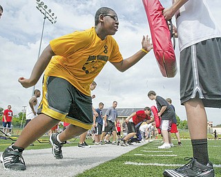Ted Everett, 13, of Youngstown was one of hundreds of young football players attending a camp at Cardinal Mooney High School on Monday.