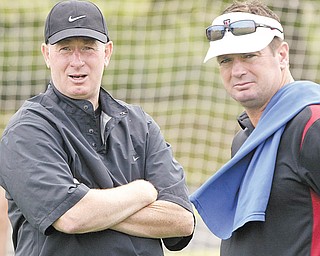 Coaches and brothers Ron, left, and Bob Stoops look on during the Camp of Champions event at Cardinal Mooney High School on Monday. Bob Stoops is the head coach at Oklahoma, and Ron Stoops is newly-named defensive backs coach at Youngstown State.