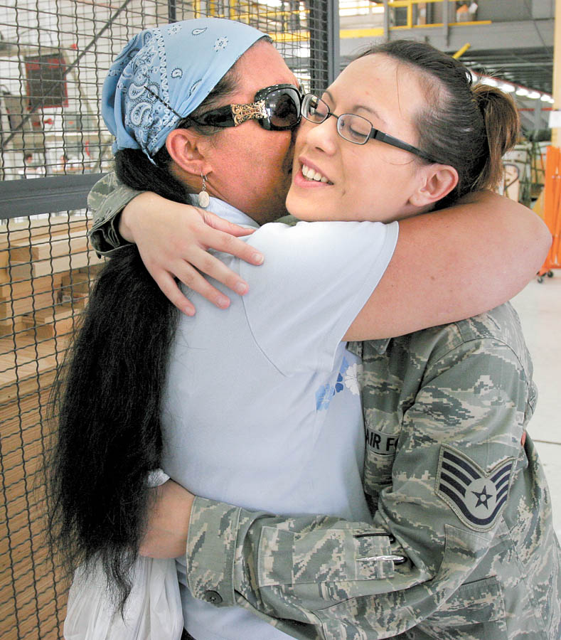Air Force Reserve Staff Sgt. Nadia Costick hugs her mother Noeleen Costick, both of Austintown, before deployment with the 910th Airlift Wing to Afghanistan on Tuesday morning from Youngstown Air Reserve 
Station in Vienna. This is her second overseas deployment. 