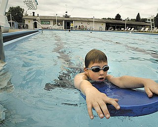 Andrew Garr, 9, of Boardman uses a fl otation board as he enjoys the pool at Logan Swim & Tennis Club in Liberty. The club is promoting a membership drive in July for the facility that offers a swimming pool with two one-meter diving boards, competitive starting blocks and shallow and deep ends. There also are tennis and basketball courts.