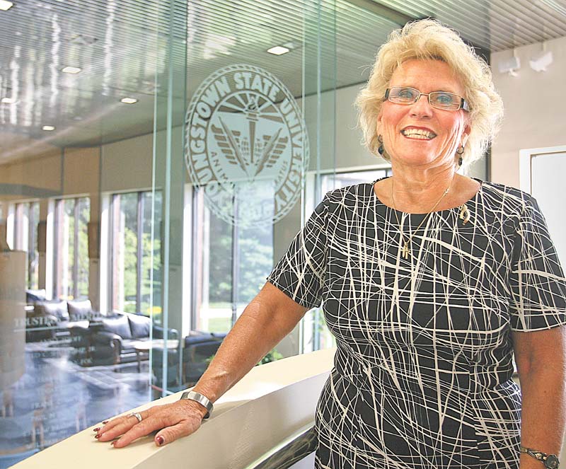 Cynthia E. Anderson begins her duties today as the seventh president of Youngstown State University. The oval-shaped pin on her left shoulder is a gift from her staff, marking her appointment as president. On one side are the letters YSU, and seven garnet stones are on the other. The seven stones signify that she is the seventh president of the university,  and garnet is her mother’s birthstone, Anderson said.