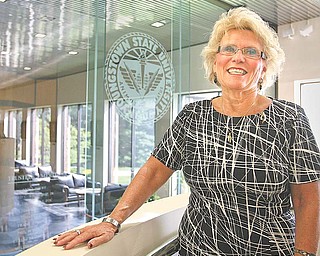 Cynthia E. Anderson begins her duties today as the seventh president of Youngstown State University. The oval-shaped pin on her left shoulder is a gift from her staff, marking her appointment as president. On one side are the letters YSU, and seven garnet stones are on the other. The seven stones signify that she is the seventh president of the university, and garnet is her mother’s birthstone, Anderson said.