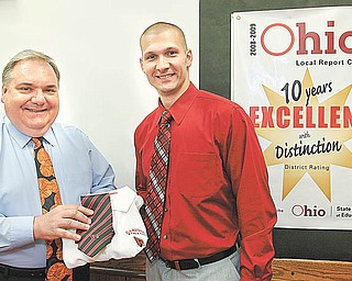 Todd Muckleroy, right, the new Canfield boys basketball coach, is welcomed by superintendent Dante Zambrini following a Board of Education meeting on Wednesday.