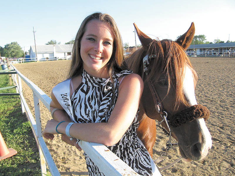 Elaine Kelley, 17, of Cortland, stands with one of her two horses, Padamay, with whom she will compete in Columbus July 30 in contesting events. Five weeks ago, another horse, Rebel, fell on her, injuring her face, shoulder, arms and legs, but she decided to compete anyway in her horse riding events two weeks ago and the Miss Trumbull County Fair contest June 28, finishing second in the queen contest and qualifying for a horse riding contest in Columbus.